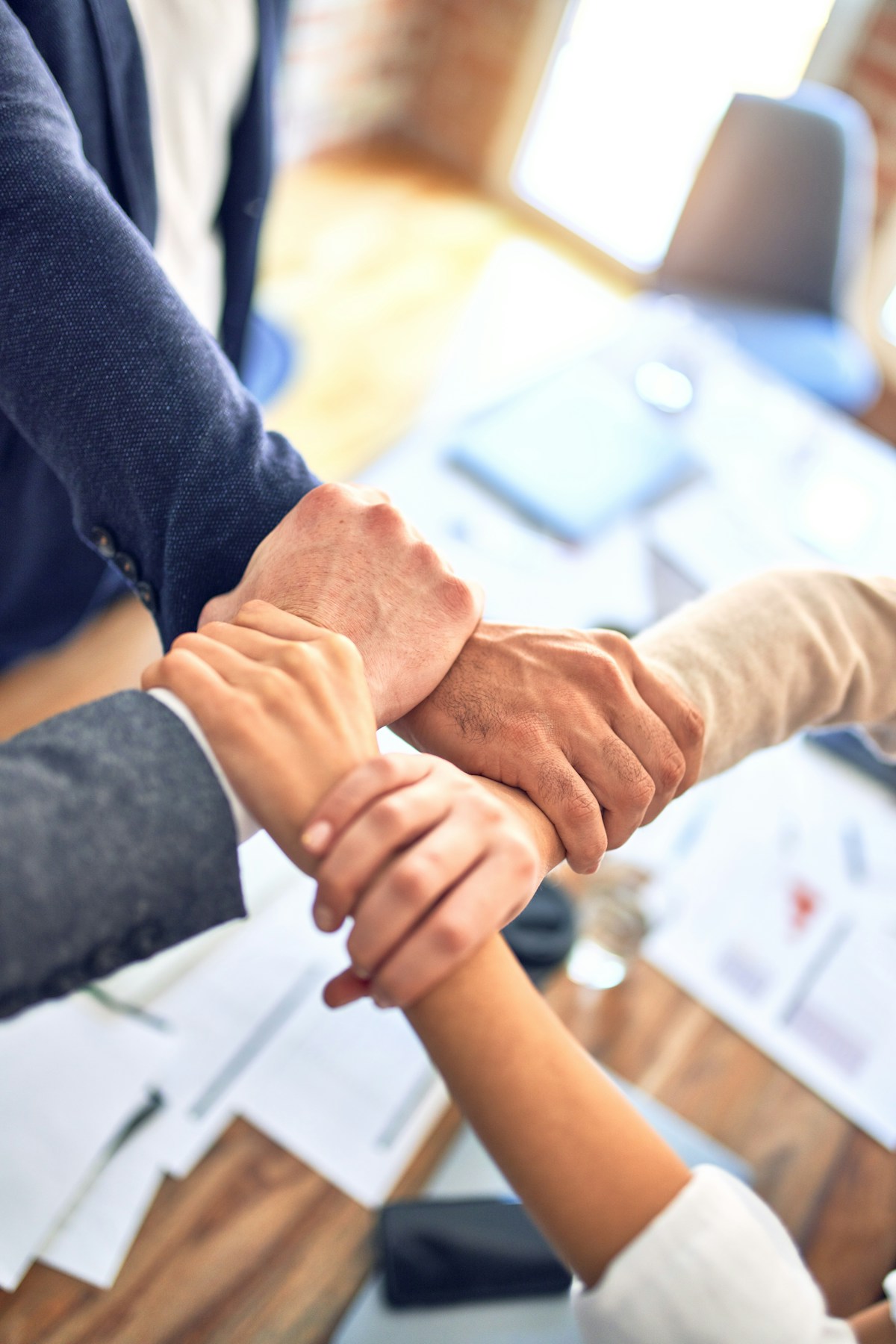 Business colleagues shaking hands in a bright office